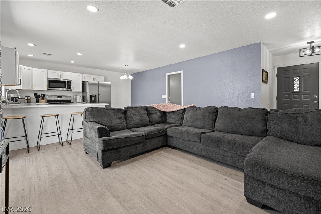 525 Van Dornum Avenue, Henderson, NV 89011 An open concept living area transitions fluidly into a sleek, well-appointed kitchen.
