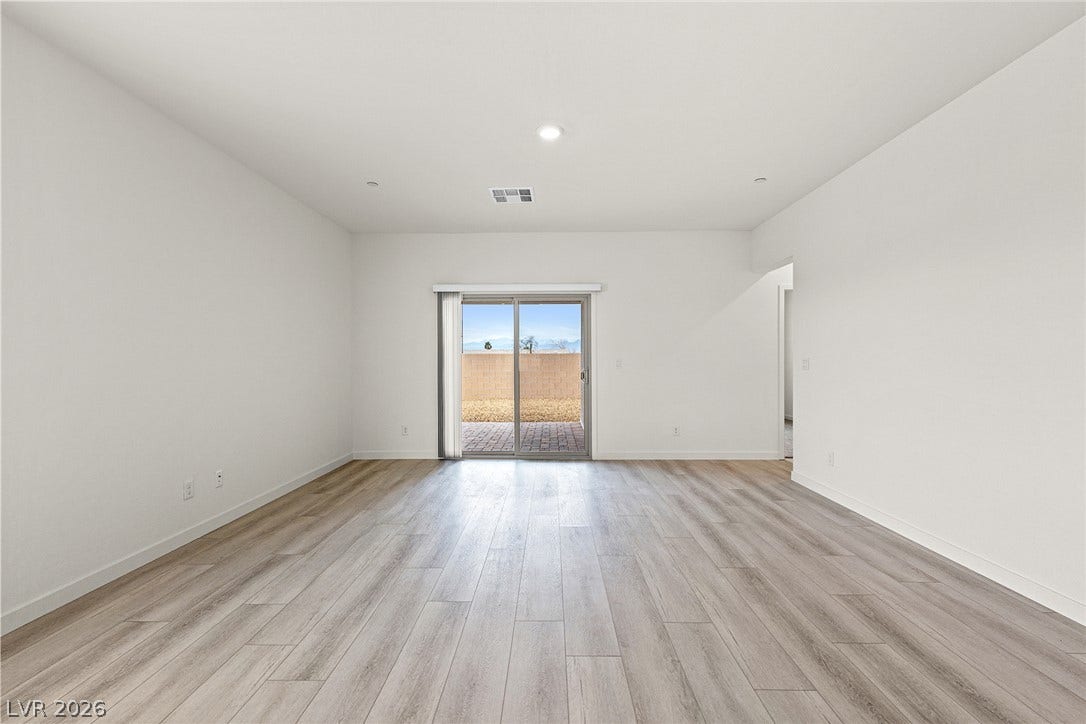 Sliding glass doors open to a sun-drenched patio from this inviting living space.
