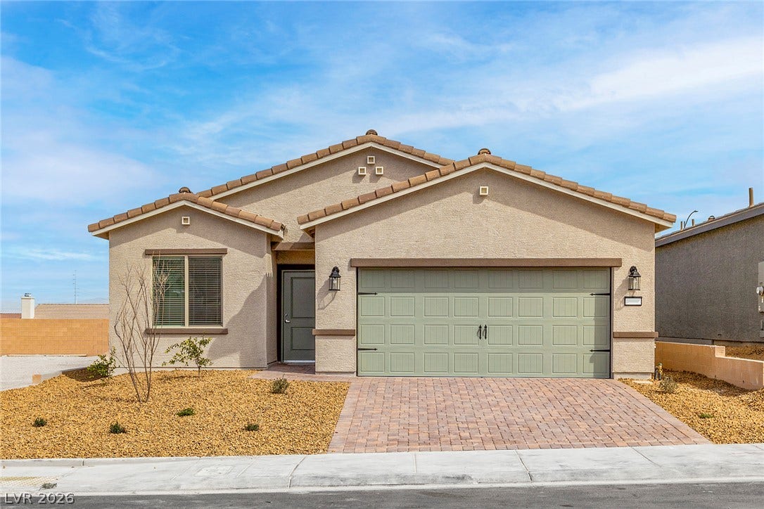 A well-maintained facade with an attached garage and desert-friendly landscaping welcomes residents home.