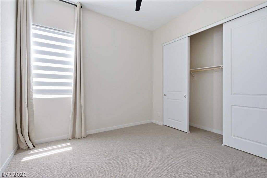 847 Eaton Falls Street, Henderson, NV 89011 A well-lit bedroom with ample closet space and plush carpeting awaits your personal touch.