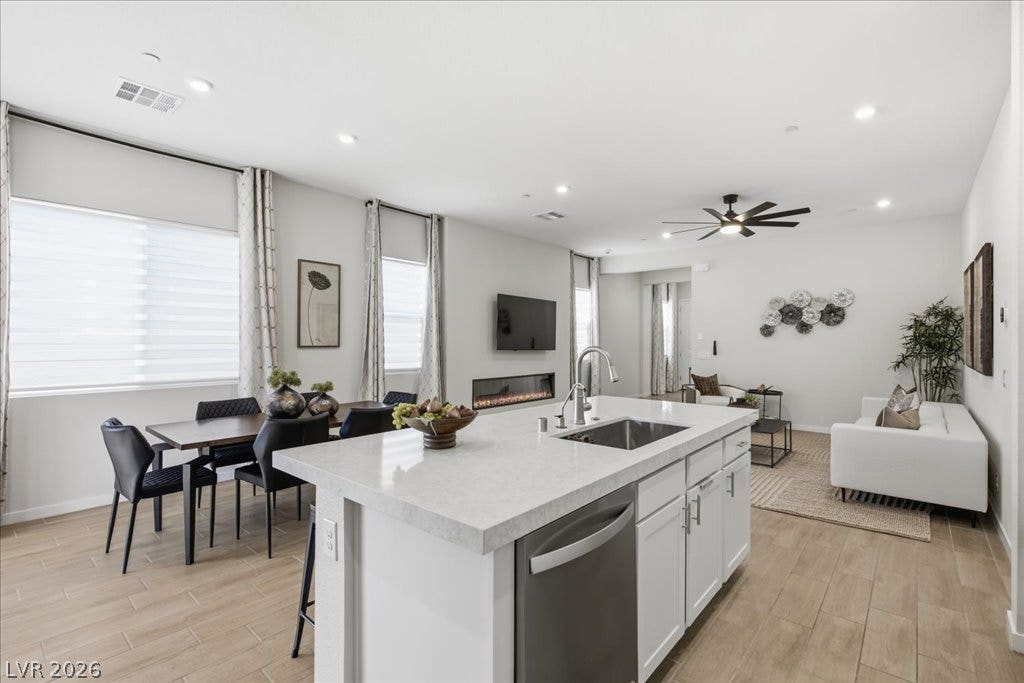 847 Eaton Falls Street, Henderson, NV 89011 Bright and open, this combined kitchen, dining, and living space boasts abundant natural light and modern amenities.