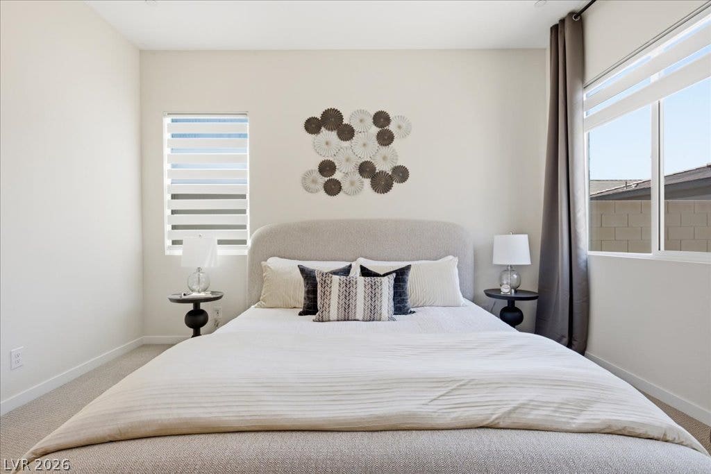 847 Eaton Falls Street, Henderson, NV 89011 The carpeted bedroom features ample natural light from the large windows.