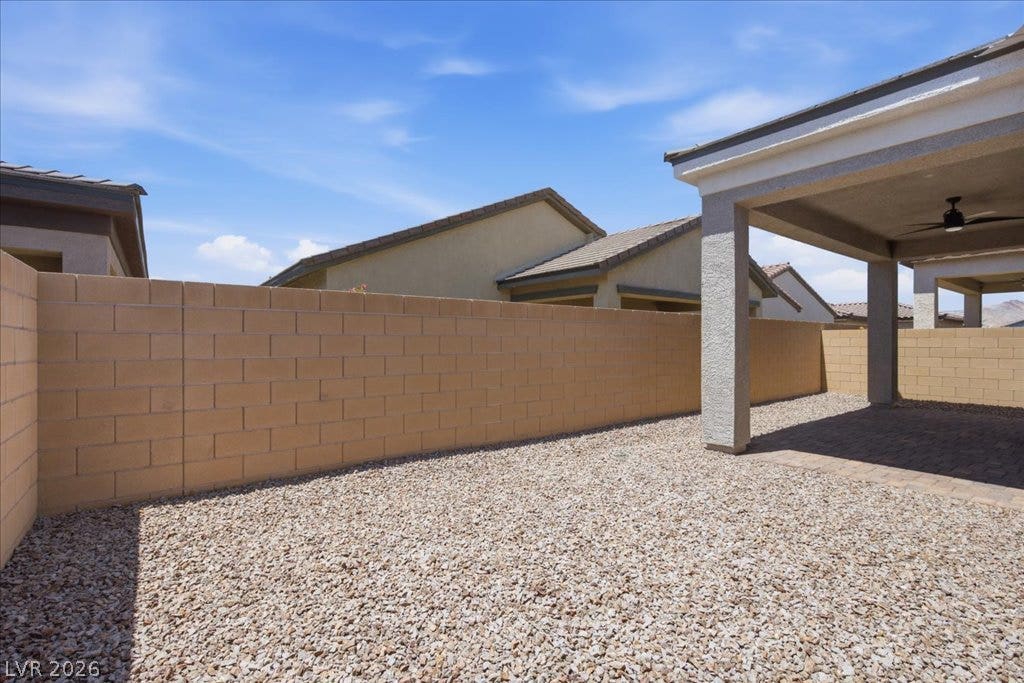 847 Eaton Falls Street, Henderson, NV 89011 Gravel landscaping and a sturdy block fence define this low-maintenance private yard.