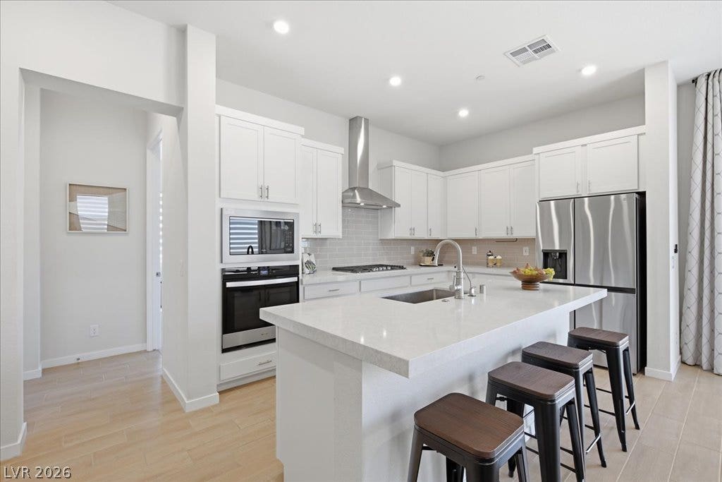 847 Eaton Falls Street, Henderson, NV 89011 A well-appointed kitchen showcasing an inviting island with seating, ideal for casual dining and entertaining.