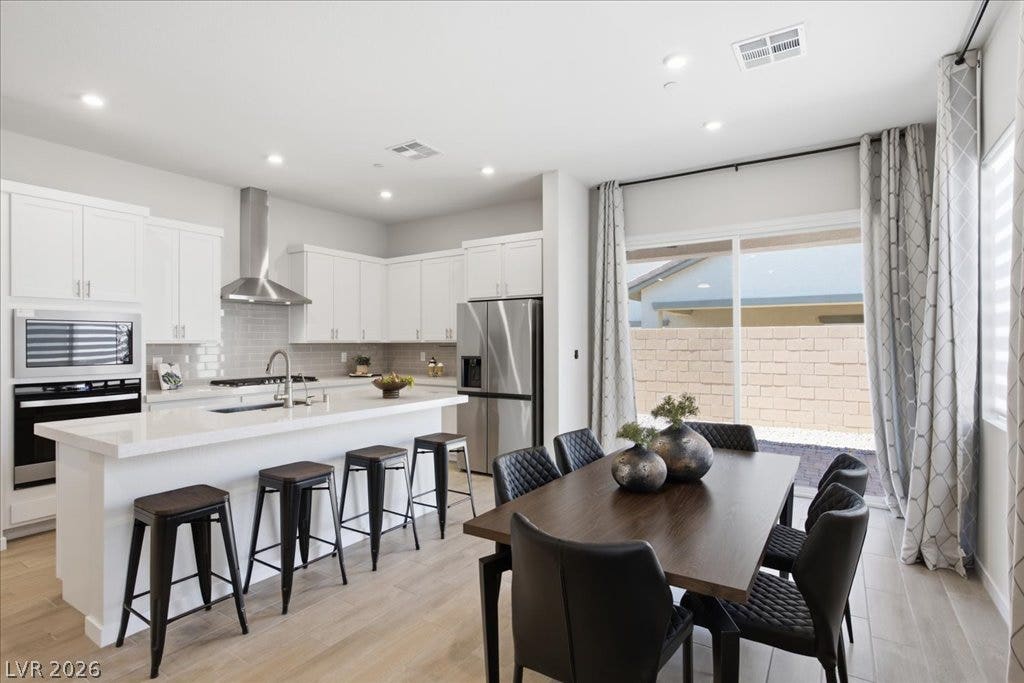 847 Eaton Falls Street, Henderson, NV 89011 A contemporary kitchen and dining area features abundant cabinetry and a bright, open feel.