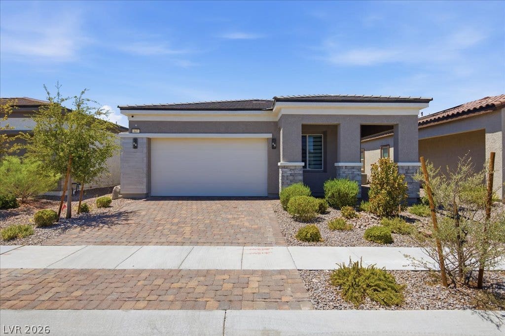 847 Eaton Falls Street, Henderson, NV 89011 A well-maintained desert landscape frames this attractive single-story residence with an inviting paver driveway.