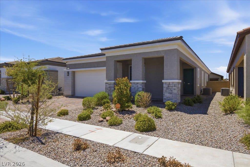 847 Eaton Falls Street, Henderson, NV 89011 Modern desert landscaping and a welcoming entry porch enhance this attractive front exterior.