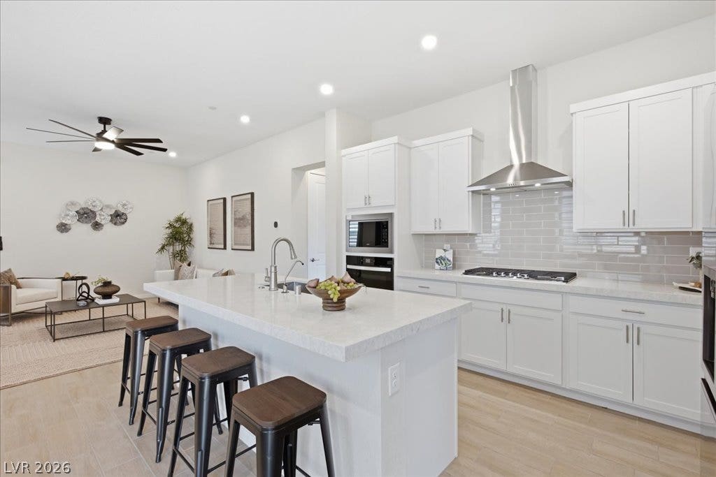 847 Eaton Falls Street, Henderson, NV 89011 An open-concept living space presents a well-appointed kitchen with an expansive island and integrated seating.