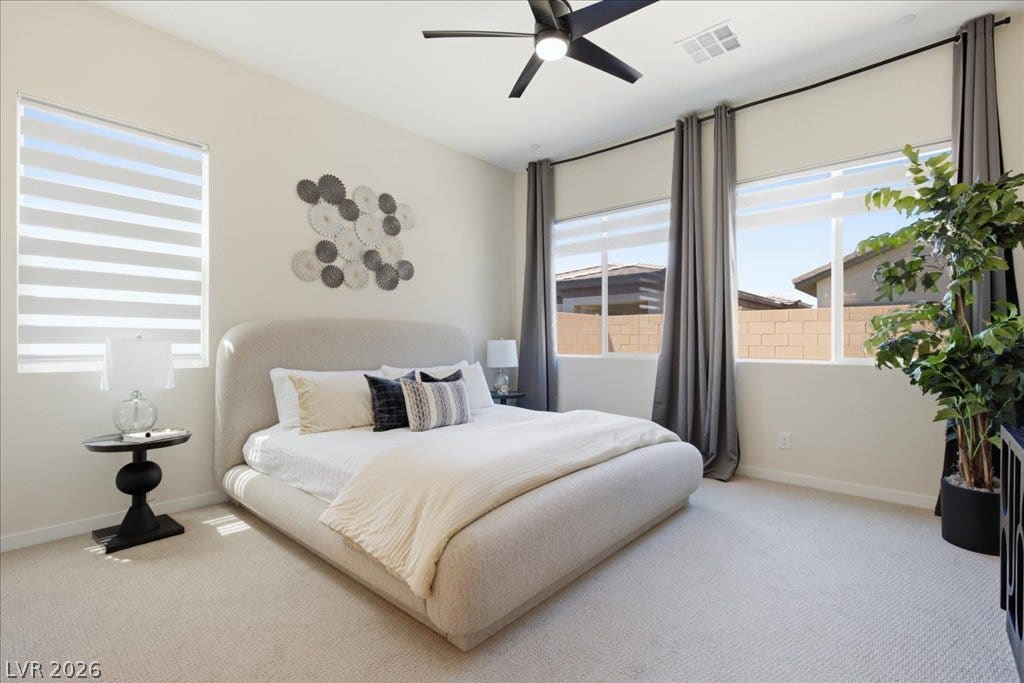 847 Eaton Falls Street, Henderson, NV 89011 A well-appointed bedroom features ample natural light and a stylish ceiling fan for comfort.
