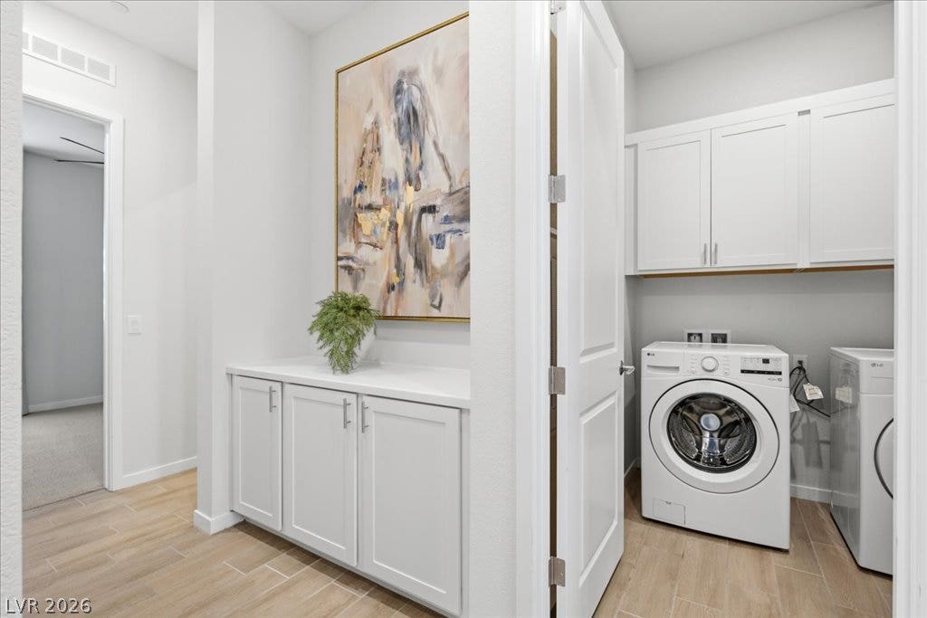 847 Eaton Falls Street, Henderson, NV 89011 Functional laundry space featuring modern appliances and storage, creating a streamlined home organization solution.