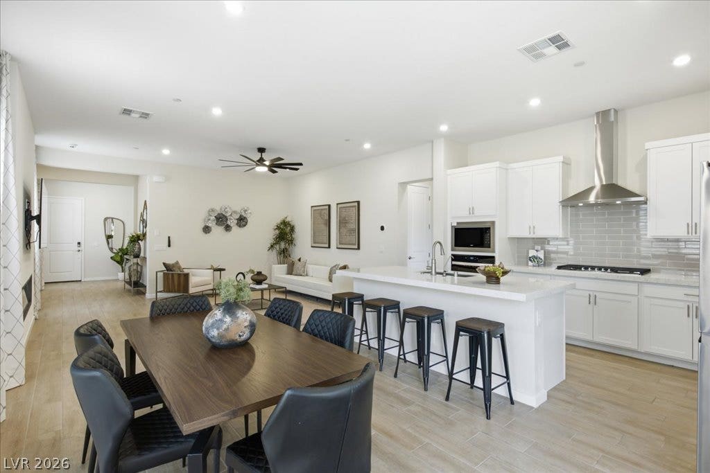 847 Eaton Falls Street, Henderson, NV 89011 An open-concept interior features a well-appointed kitchen flowing seamlessly into a dining area and living space.