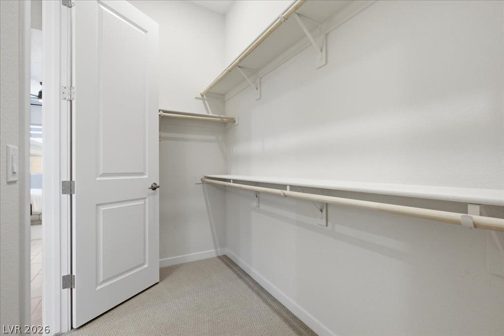 847 Eaton Falls Street, Henderson, NV 89011 Ample shelving and hanging space offer organized storage within this tidy walk-in closet.