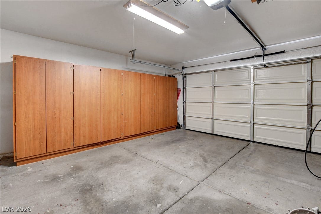 8308 Raphael Court, Las Vegas, NV 89129 A well-appointed garage with extensive built-in storage cabinets offers optimal organization and utility.
