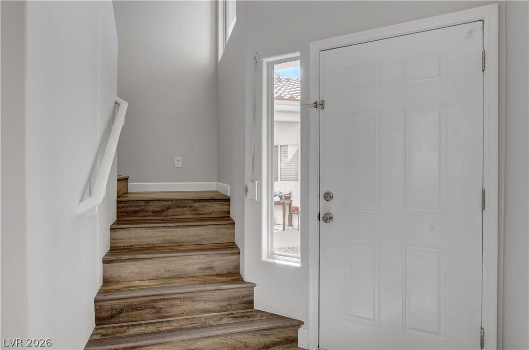 8308 Raphael Court, Las Vegas, NV 89129 A welcoming entry features durable wood flooring leading to a split-level staircase.