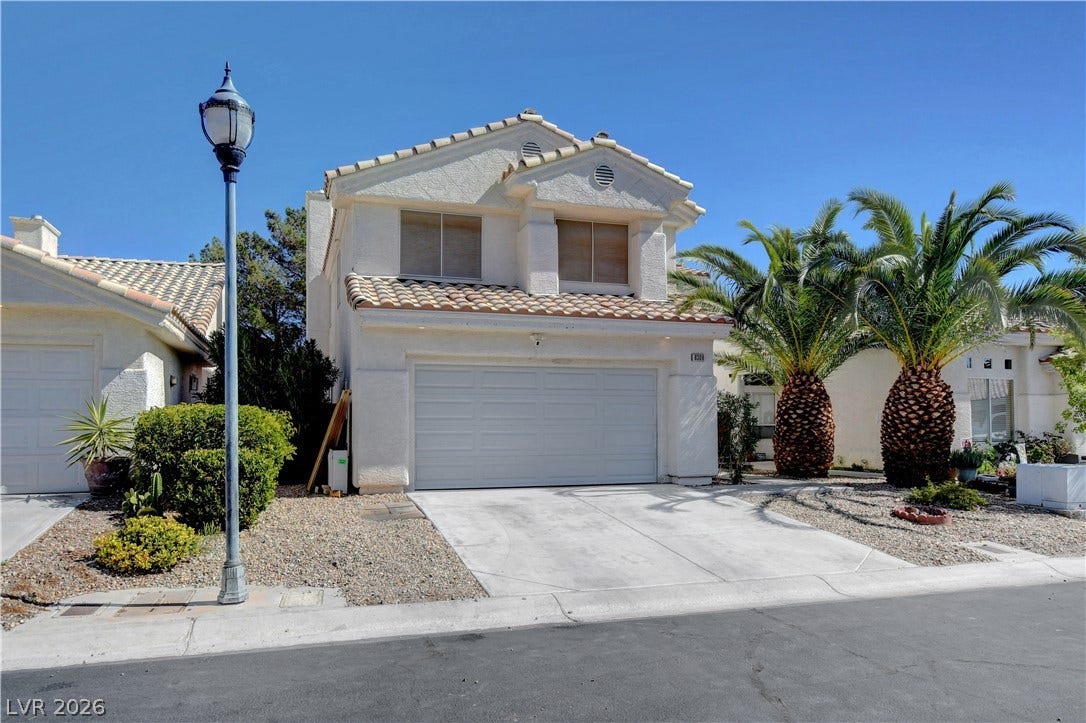 8308 Raphael Court, Las Vegas, NV 89129 A well-maintained stucco home with a tile roof and attached garage offers welcoming curb appeal.