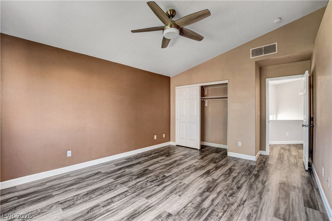 8308 Raphael Court, Las Vegas, NV 89129 A generously sized bedroom features stylish wood flooring and a convenient sliding closet.
