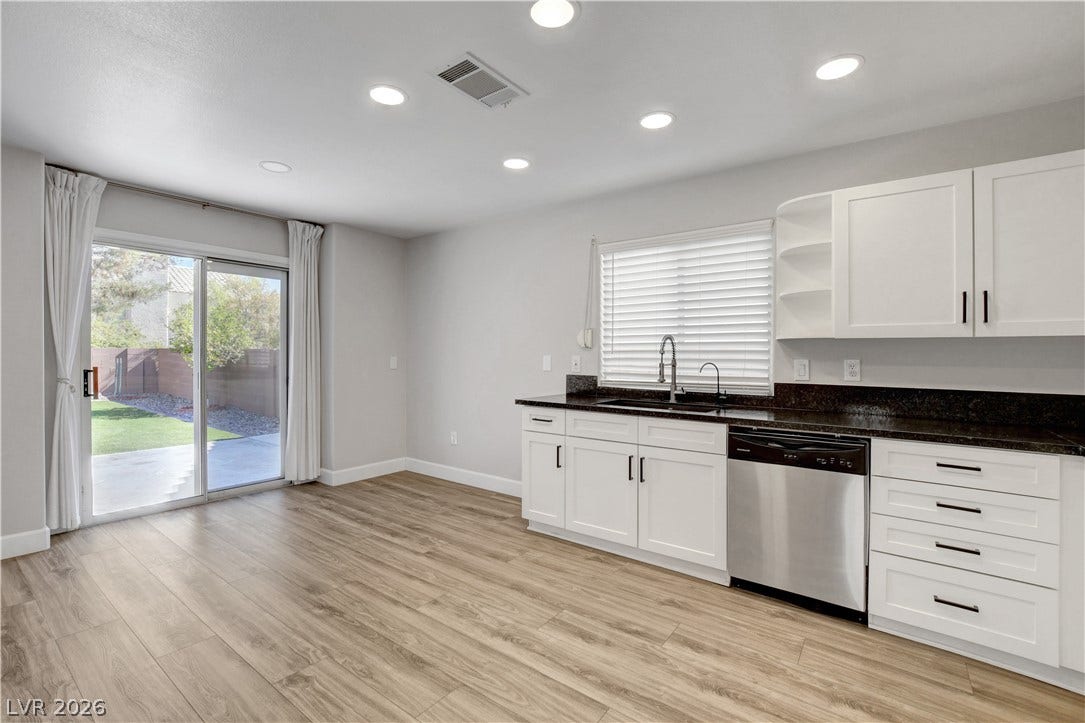 8308 Raphael Court, Las Vegas, NV 89129 Bright, airy kitchen space with modern cabinetry and convenient patio access.