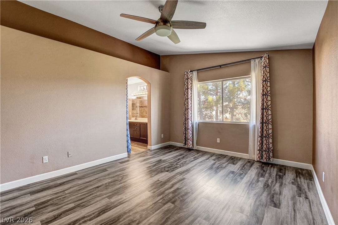 8308 Raphael Court, Las Vegas, NV 89129 Well-lit room featuring wood-look flooring and a window offering views of the outdoors.