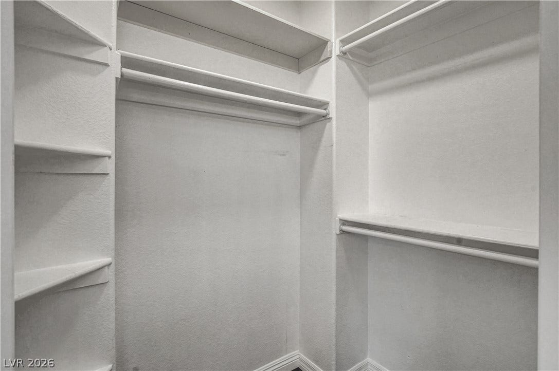 8308 Raphael Court, Las Vegas, NV 89129 Ample shelving and hanging space define this functional closet, ready for organization.