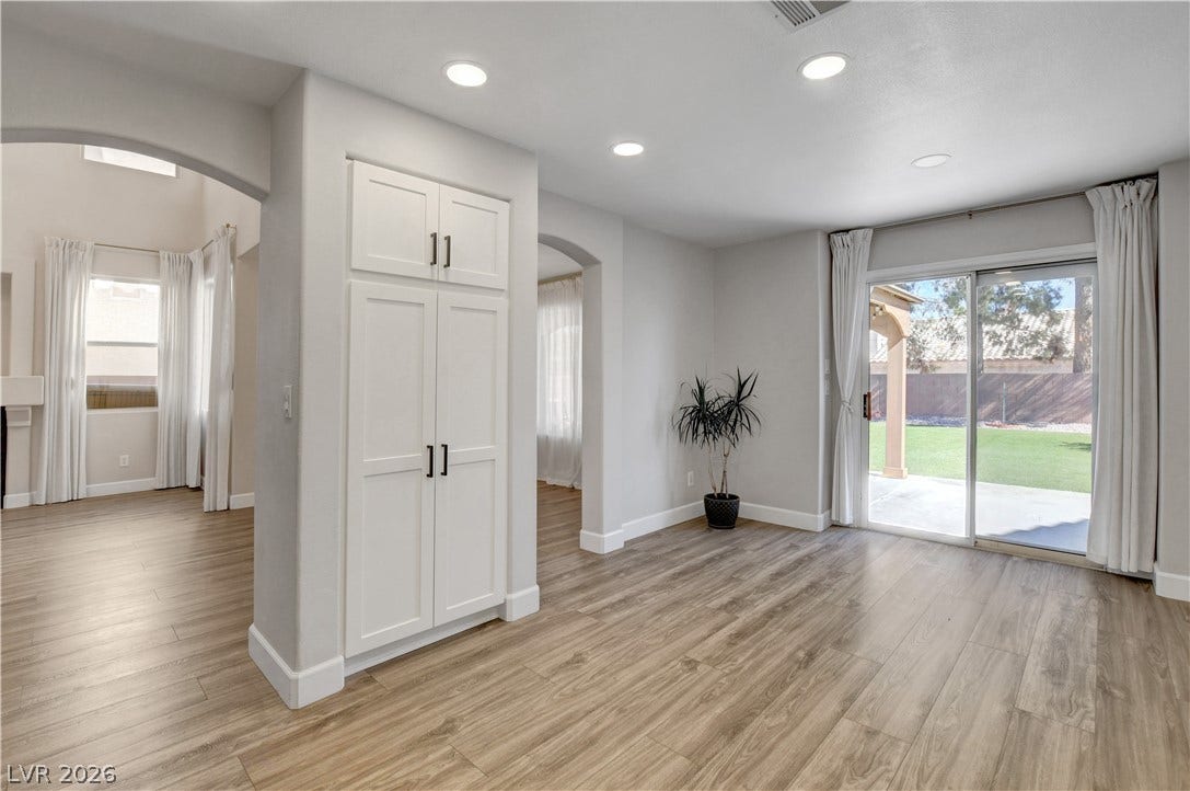 8308 Raphael Court, Las Vegas, NV 89129 Luminous interior spaces feature warm wood flooring and access to a green backyard.