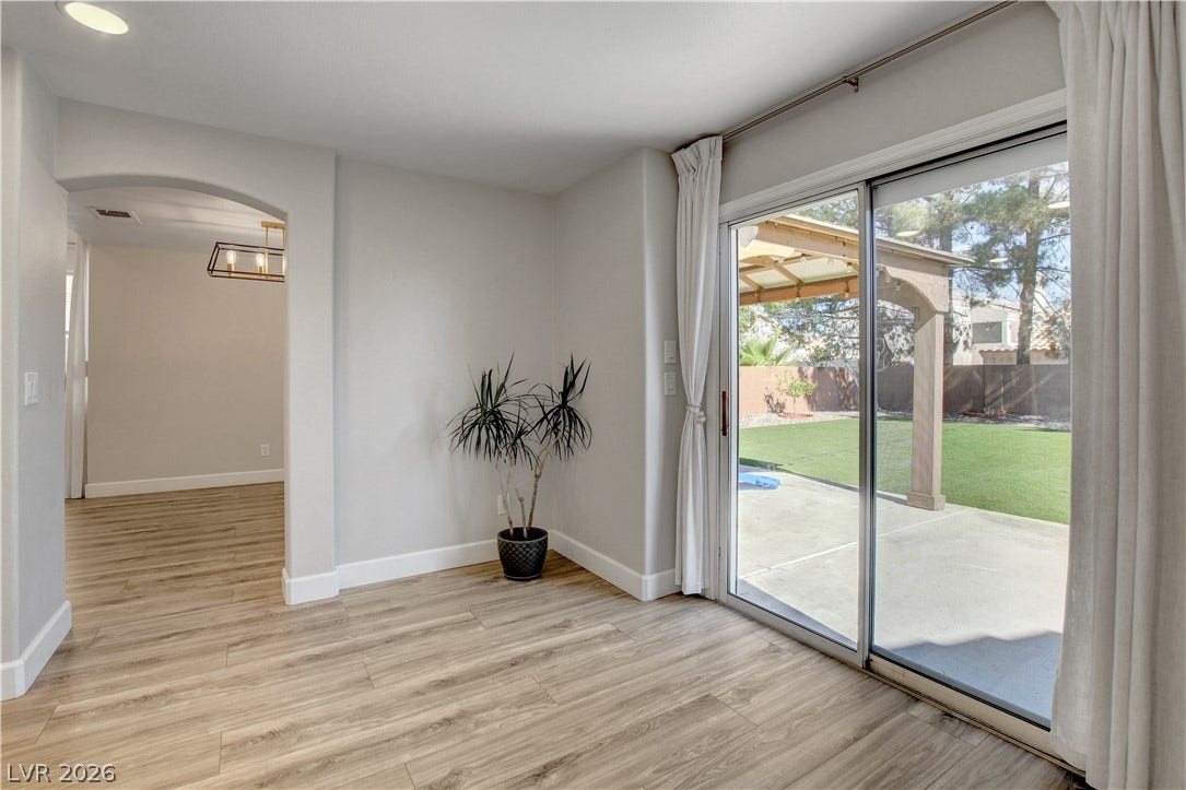 8308 Raphael Court, Las Vegas, NV 89129 Sliding glass doors open to a generous patio and well-maintained private yard.