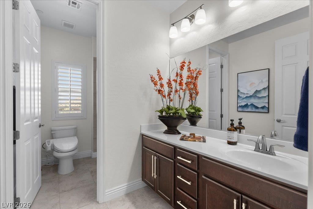 2828 Josephine Drive, Henderson, NV 89044 Hall bath off upstairs loft. Sleek vanity with ample counter space and a modern toilet with bidet functionality complement this well-appointed bathroom.