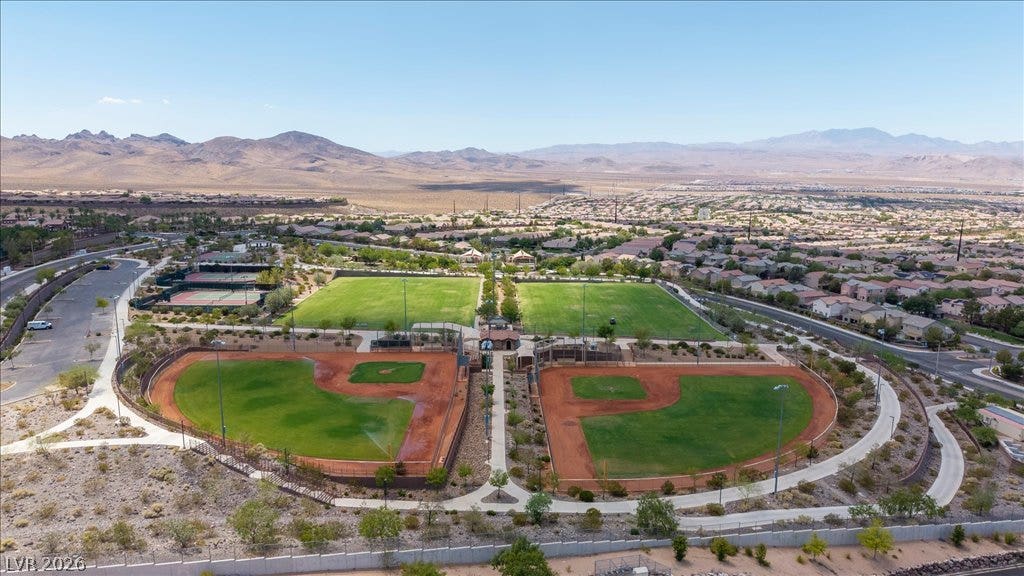 2828 Josephine Drive, Henderson, NV 89044 An aerial panorama reveals extensive baseball fields, tennis courts, and residential community nestled against desert mountains.