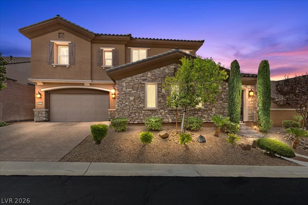 2828 Josephine Drive, Henderson, NV 89044 A well-landscaped front yard with a charming stone facade welcomes visitors to this inviting residence.