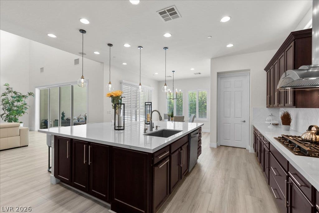 2828 Josephine Drive, Henderson, NV 89044 A well-appointed kitchen features a large central island with seating, pendant lighting, and stainless steel appliances.