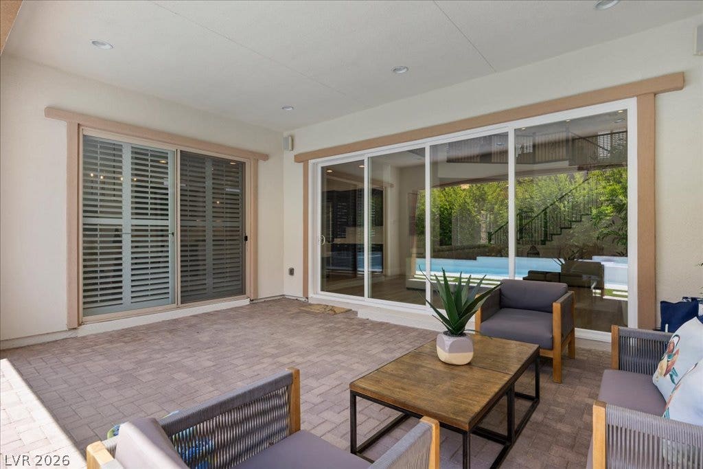 2828 Josephine Drive, Henderson, NV 89044 An inviting covered patio featuring paver flooring offers a seamless transition to the refreshing pool area.