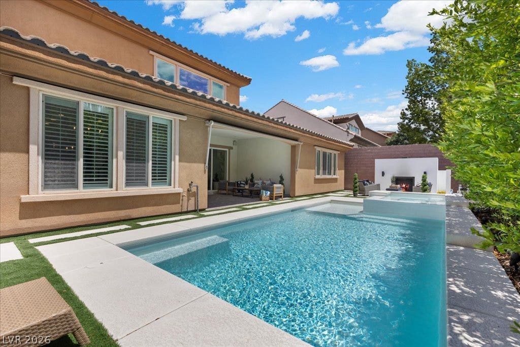 2828 Josephine Drive, Henderson, NV 89044 An inviting backyard oasis awaits with a sparkling pool, adjacent spa, and a cozy outdoor covered patio.