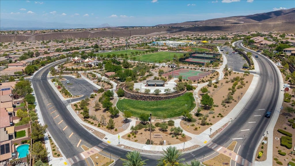 2828 Josephine Drive, Henderson, NV 89044 An aerial perspective reveals a vibrant community park with recreational amenities, surrounded by residential streets and distant mountains.