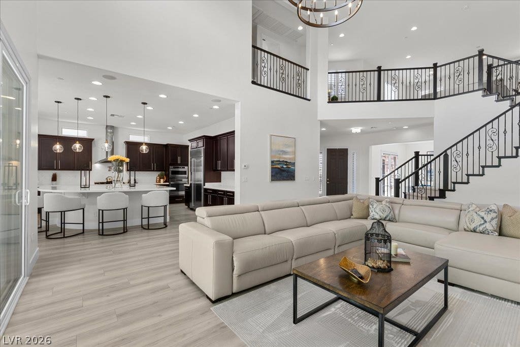 2828 Josephine Drive, Henderson, NV 89044 A grand, open-concept living space integrates a modern kitchen and an elegant staircase with wrought-iron railings.