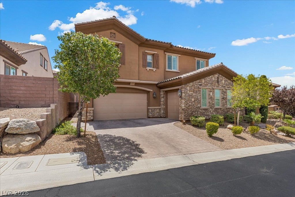 2828 Josephine Drive, Henderson, NV 89044 A striking facade with warm earth tones, stone accents, and inviting landscaping.