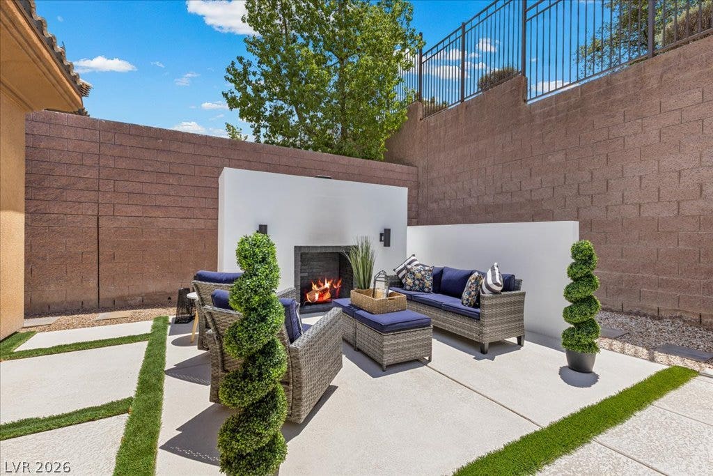 2828 Josephine Drive, Henderson, NV 89044 An inviting outdoor patio features a custom cozy fireplace, perfect for serene evenings and entertaining.