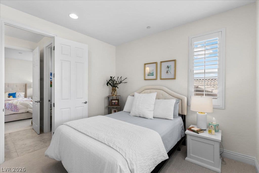 2828 Josephine Drive, Henderson, NV 89044 A quiet secondary bedroom features a window with plantation shutters and direct access to an adjoining room.