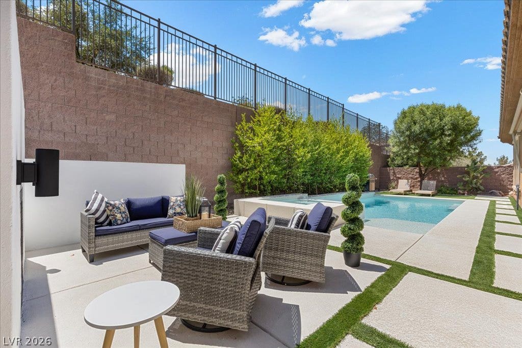 2828 Josephine Drive, Henderson, NV 89044 A tranquil custom outdoor living space boasts a glistening pool and a relaxing patio, perfect for entertaining.