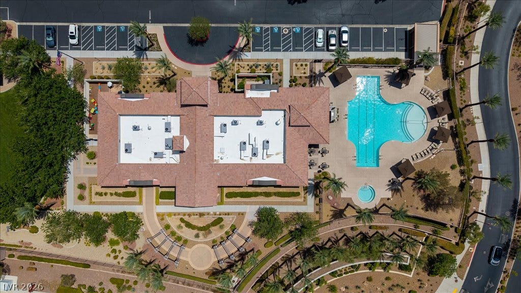 2828 Josephine Drive, Henderson, NV 89044 An aerial perspective reveals a vibrant community hub with a shimmering pool, ample parking, and meticulously landscaped grounds.