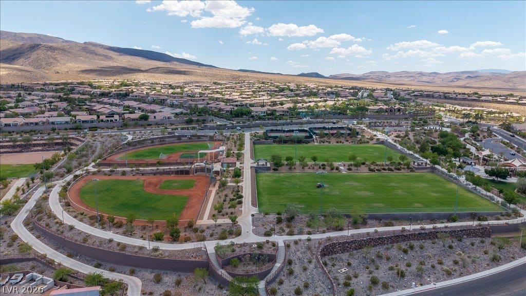 2828 Josephine Drive, Henderson, NV 89044 An aerial perspective showcases the community's recreational fields and surrounding residential landscape nestled against a mountainous backdrop.