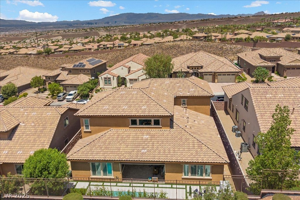 2828 Josephine Drive, Henderson, NV 89044 An aerial perspective reveals a residential community nestled against a distant mountainous landscape.