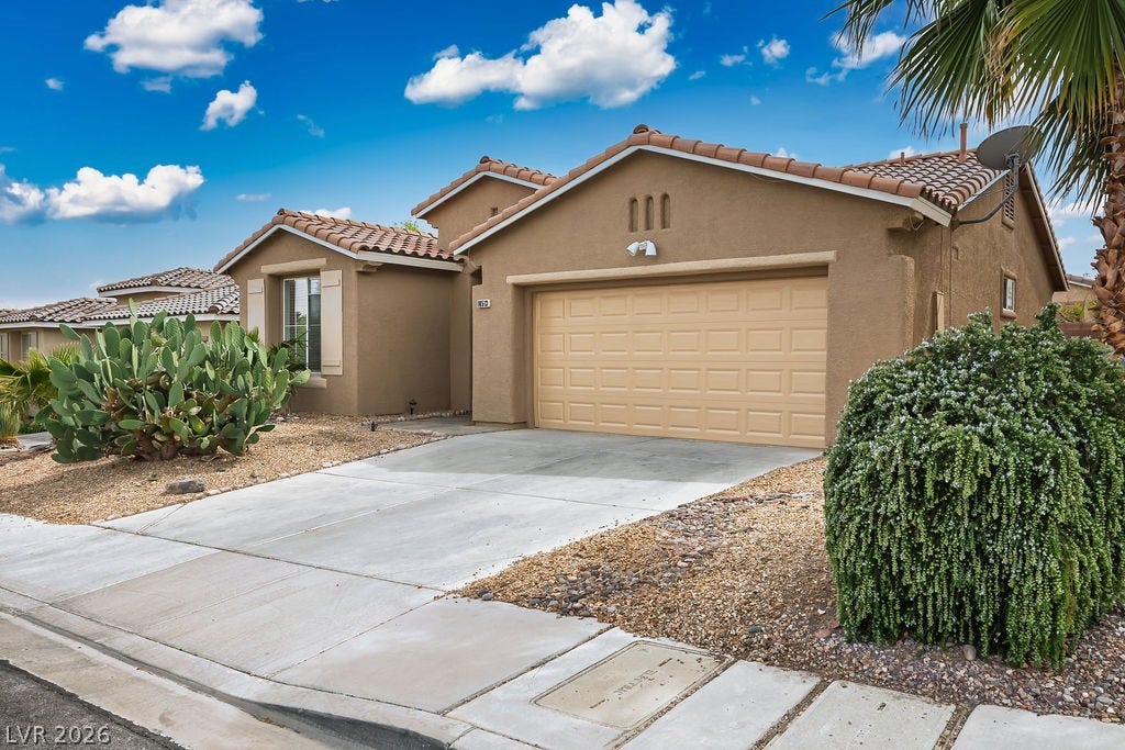 10513 Shanna Trellis Avenue, Las Vegas, NV 89144 Mediterranean / spanish house featuring stucco siding, an attached garage, concrete driveway, and a tiled roof
