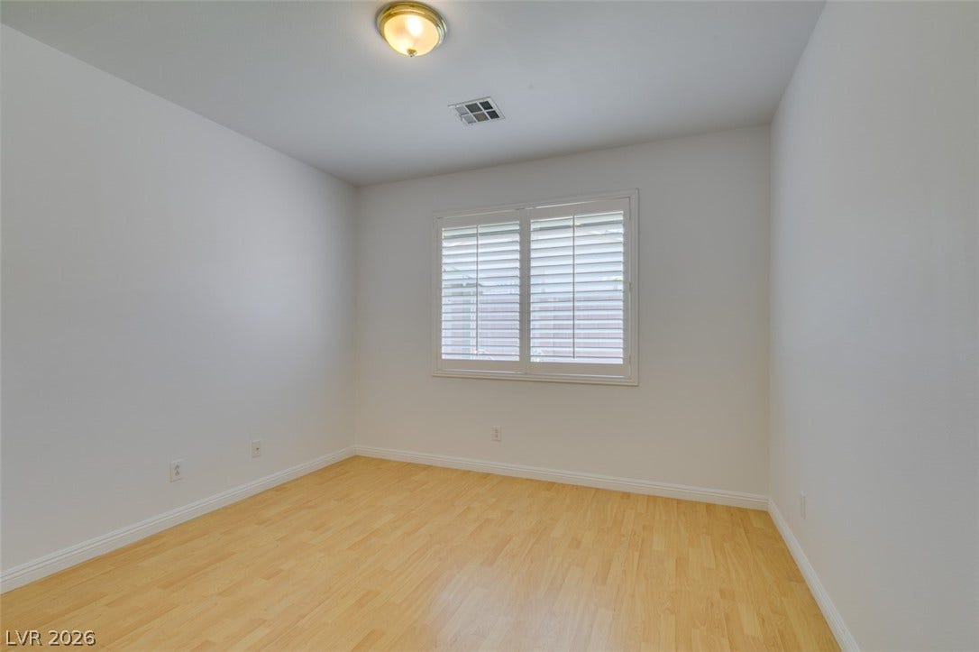 10513 Shanna Trellis Avenue, Las Vegas, NV 89144 Spare room featuring wood finished floors and baseboards