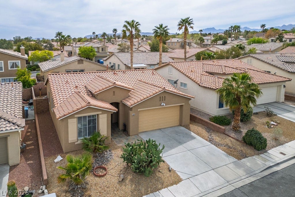 10513 Shanna Trellis Avenue, Las Vegas, NV 89144 Mediterranean / spanish-style home with a residential view, stucco siding, a garage, concrete driveway, and a mountain view