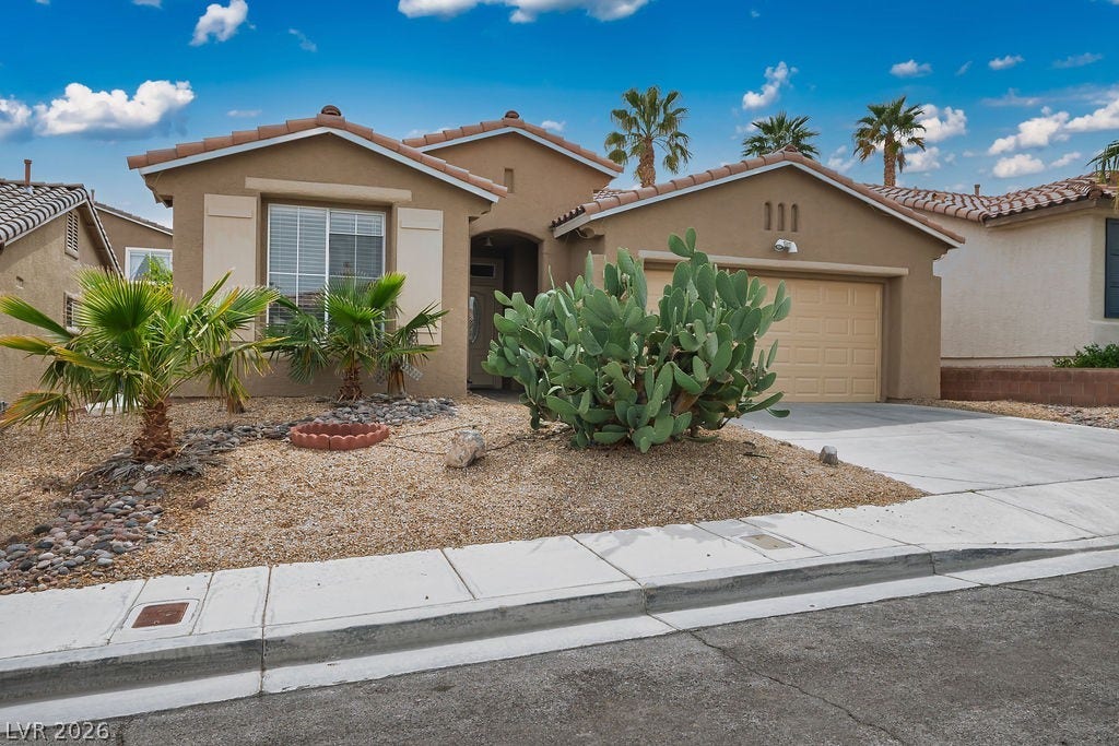 10513 Shanna Trellis Avenue, Las Vegas, NV 89144 Mediterranean / spanish-style home with stucco siding, driveway, an attached garage, and a tile roof