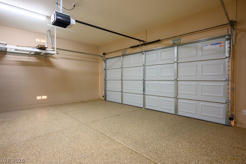10513 Shanna Trellis Avenue, Las Vegas, NV 89144 Garage with baseboards and a garage door opener