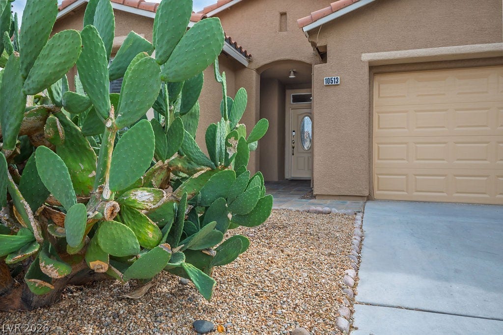 10513 Shanna Trellis Avenue, Las Vegas, NV 89144 Entrance to property featuring a tile roof and stucco siding