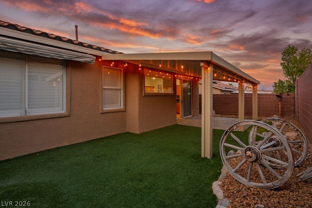10513 Shanna Trellis Avenue, Las Vegas, NV 89144 Yard at dusk with a fenced backyard and a patio area