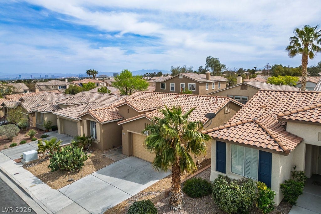 10513 Shanna Trellis Avenue, Las Vegas, NV 89144 Mediterranean / spanish-style home with a residential view, stucco siding, a garage, and concrete driveway