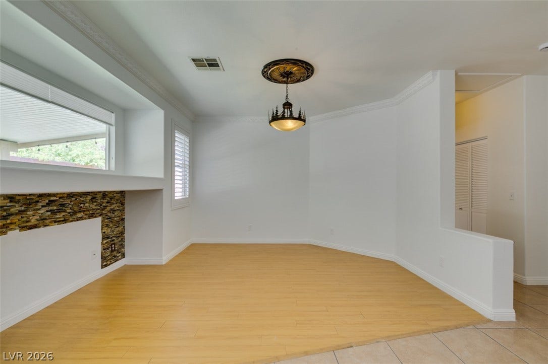 10513 Shanna Trellis Avenue, Las Vegas, NV 89144 Unfurnished dining area with crown molding and light wood-type flooring