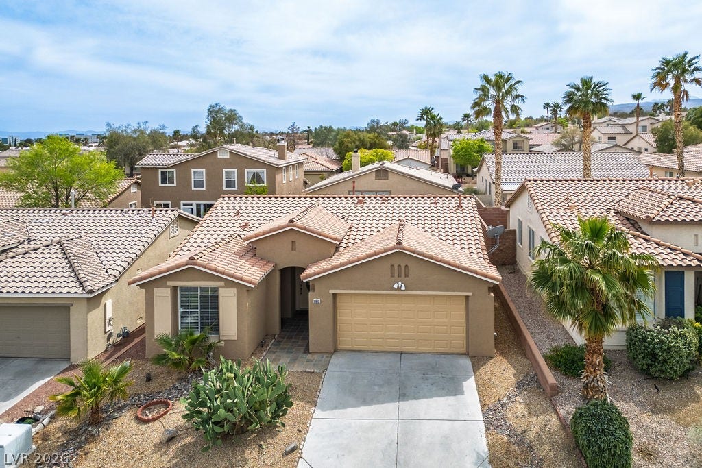 10513 Shanna Trellis Avenue, Las Vegas, NV 89144 Mediterranean / spanish-style house featuring a residential view, stucco siding, driveway, a garage, and a tiled roof